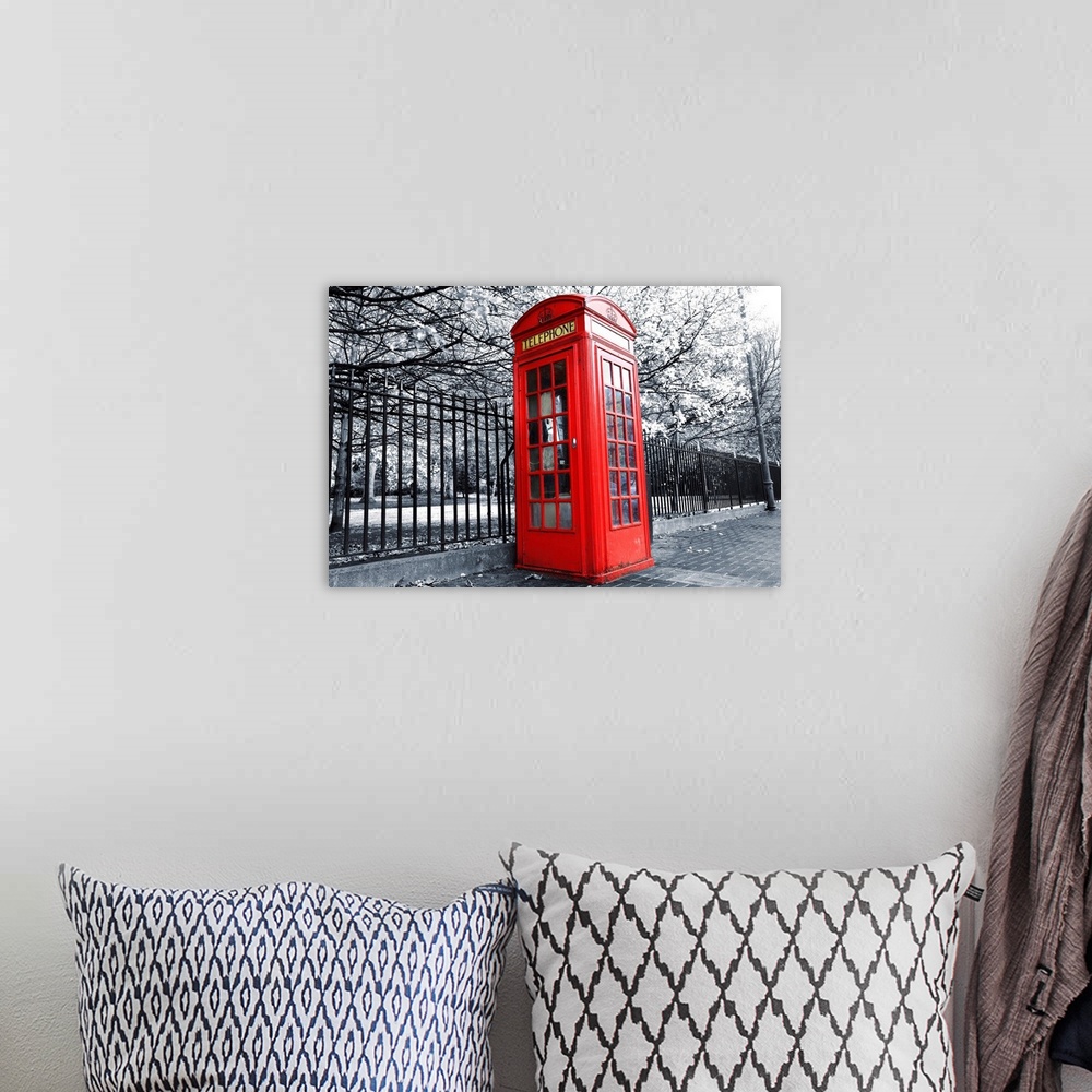 A bohemian room featuring Large black and white photo on canvas with a phone booth kept in color.