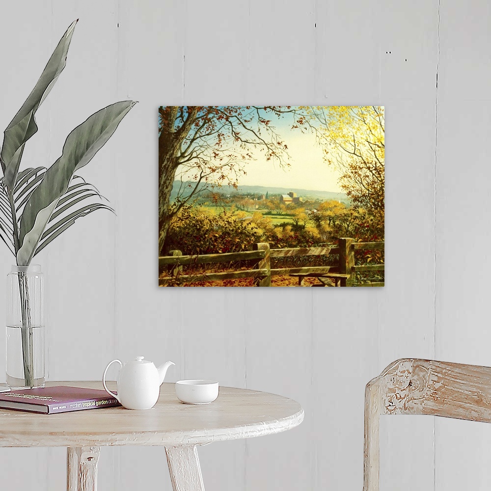 A farmhouse room featuring Idyllic painting of a rural landscape, with a village in the distance.