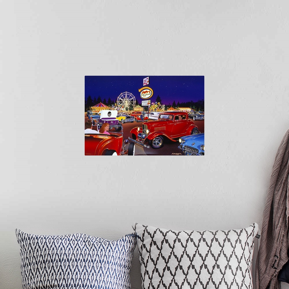 A bohemian room featuring Big painting of antique cars in the parking lot of an amusement park that is lit up in bright col...