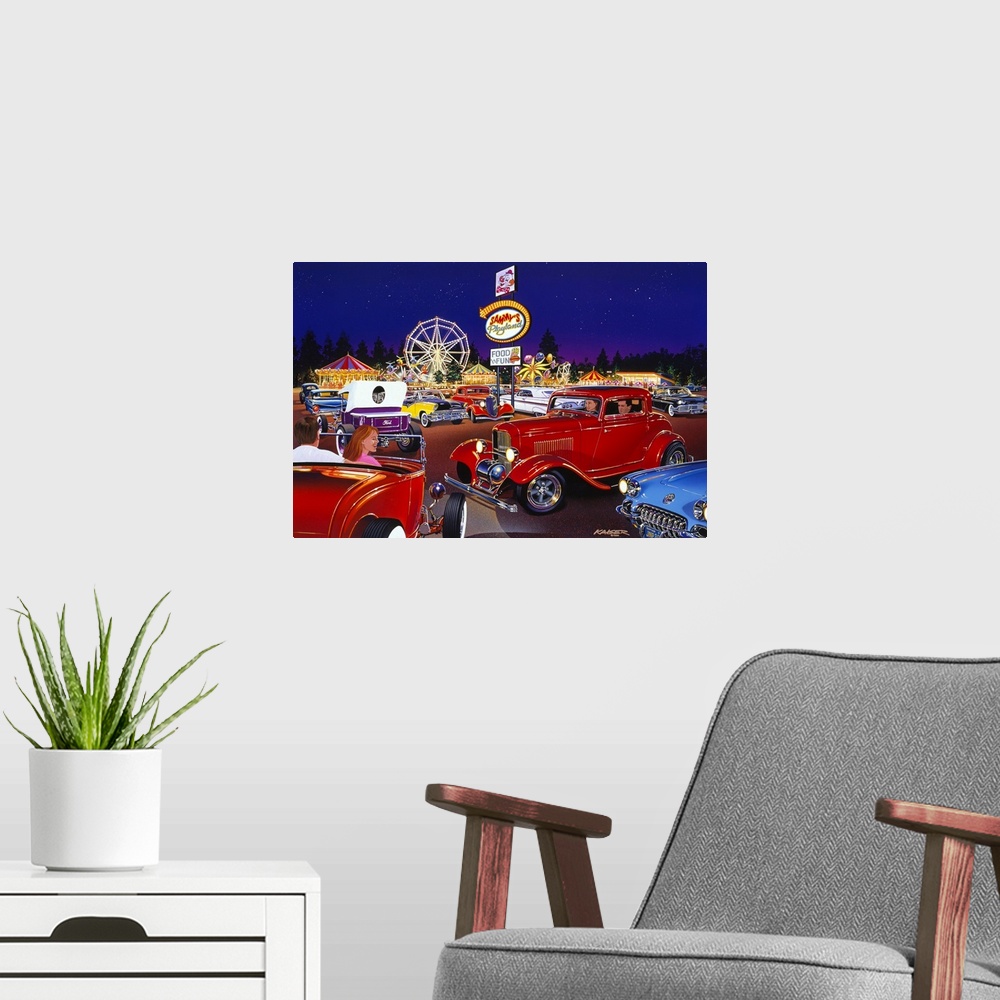 A modern room featuring Big painting of antique cars in the parking lot of an amusement park that is lit up in bright col...