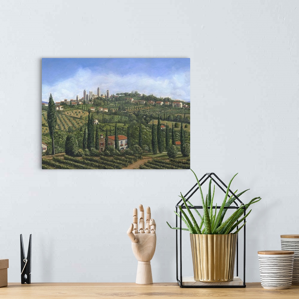 A bohemian room featuring Contemporary artwork of an European valley scattered with villages, home and vineyards.
