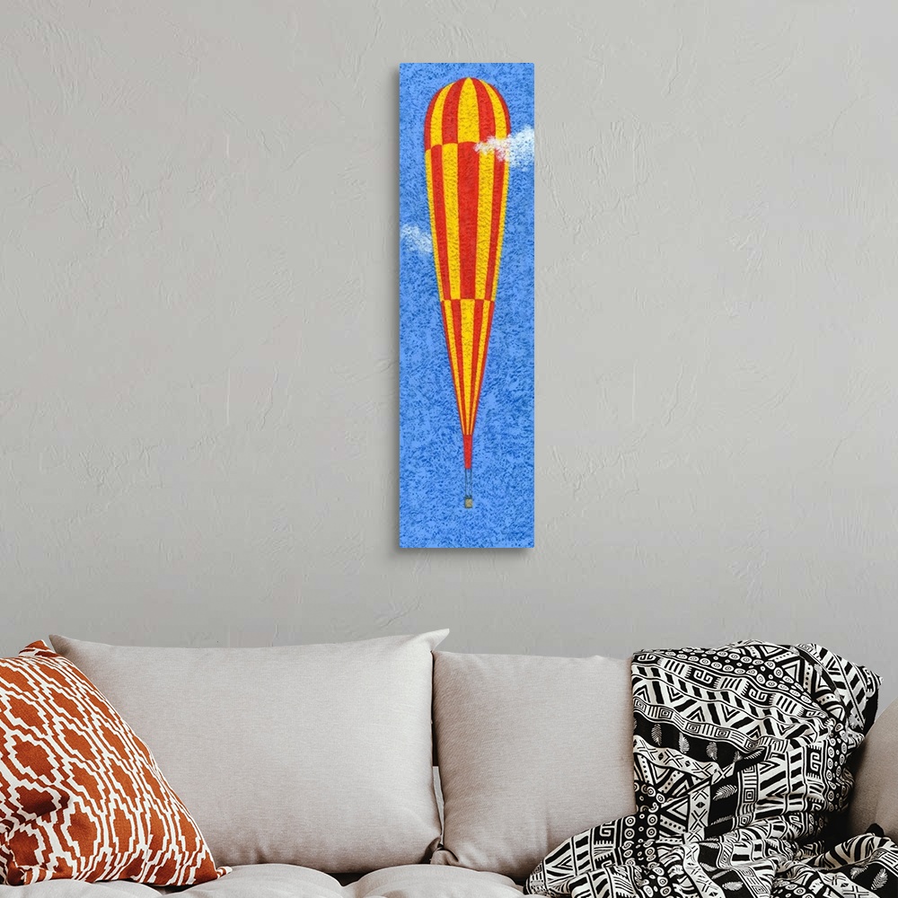 A bohemian room featuring Contemporary painting of a tall yellow and red striped hot air balloon against a blue sky.