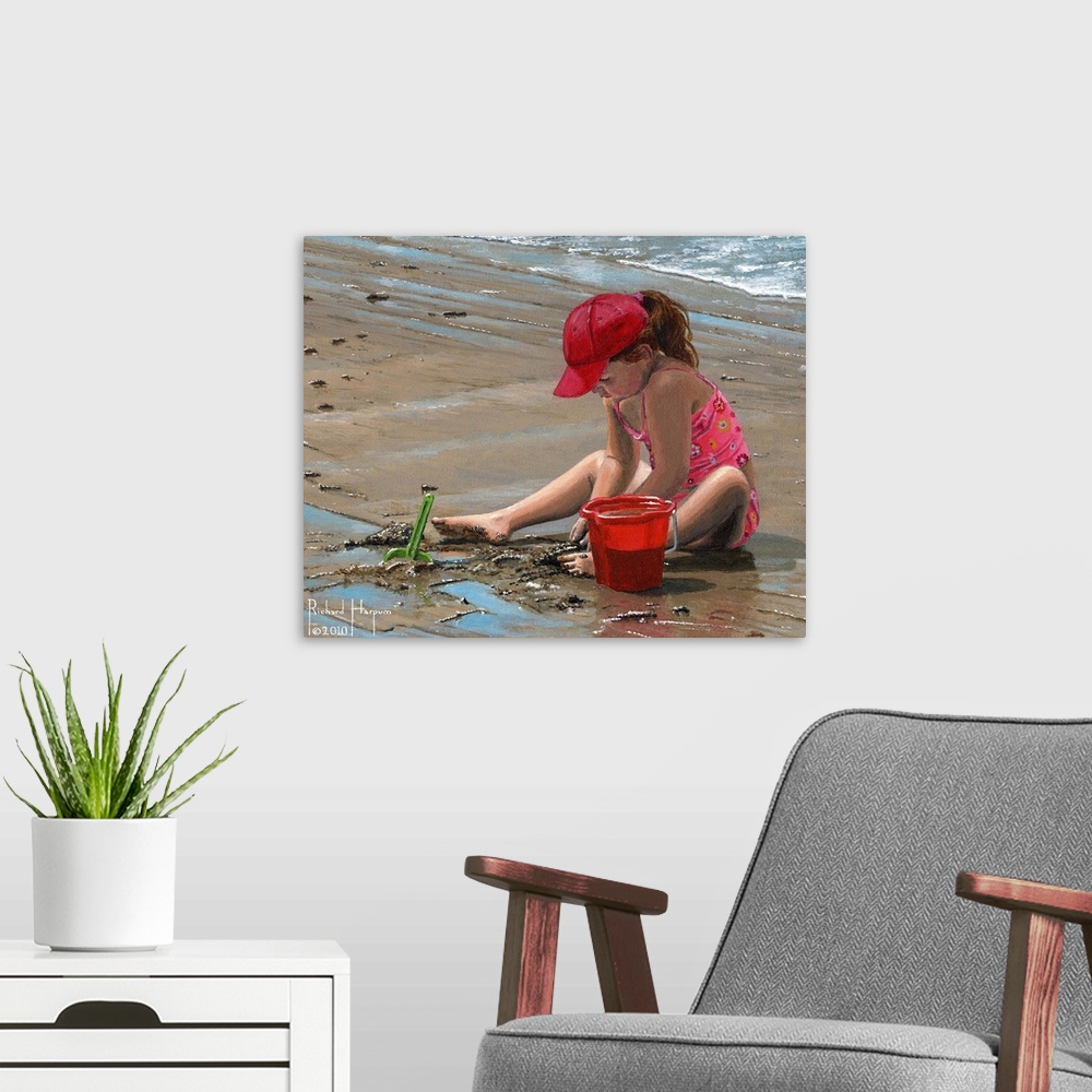 A modern room featuring Contemporary artwork of a little girl playing in the sand on the beach.