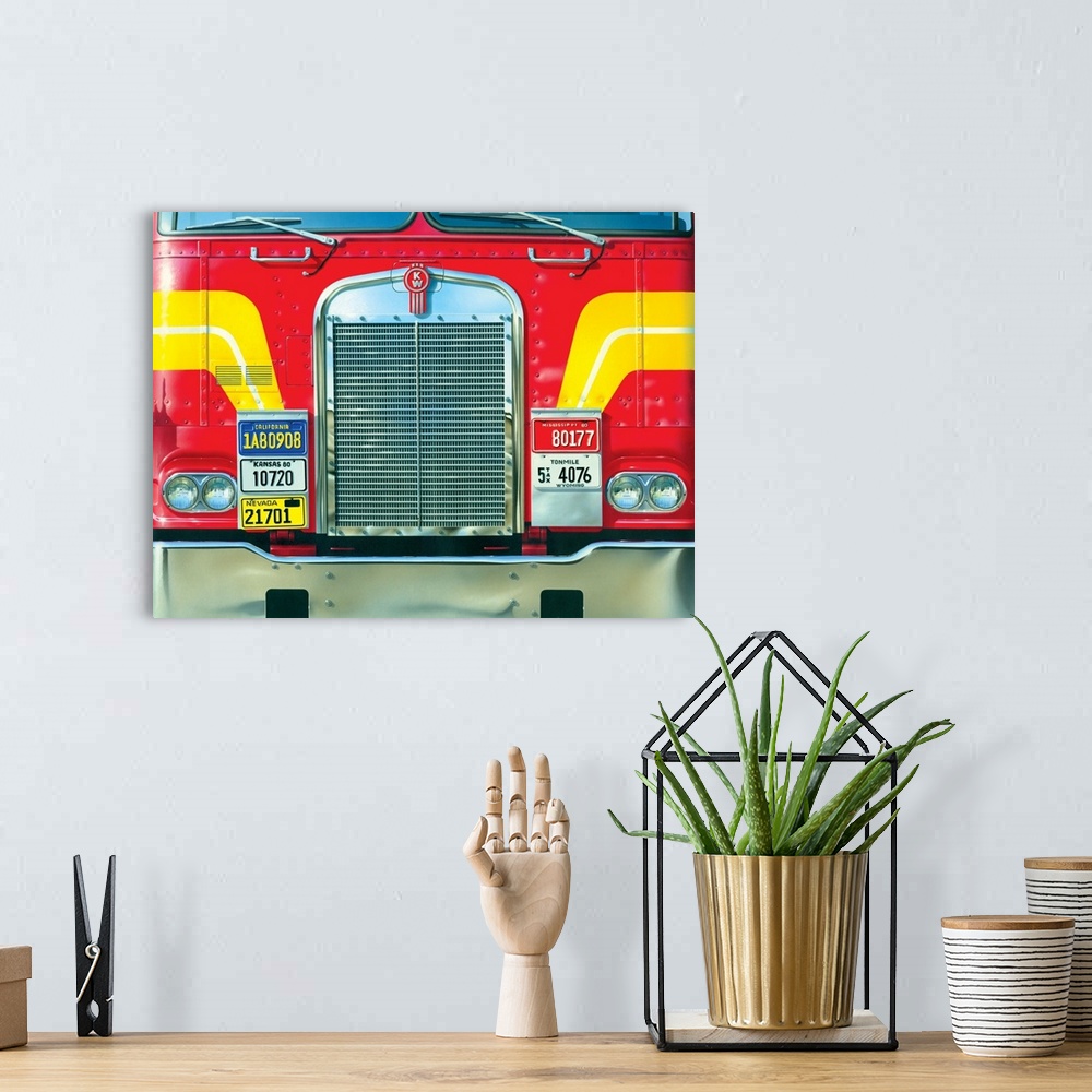 A bohemian room featuring Contemporary artwork of the front of a very large red truck with yellow stripes.