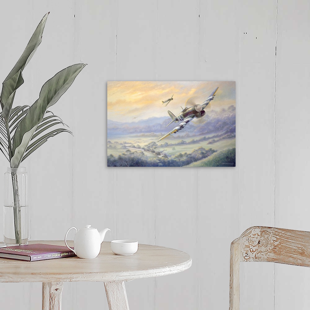 A farmhouse room featuring Contemporary artwork of military fighter planes flying over a rural landscape with tank caravan m...