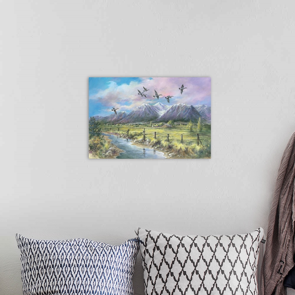 A bohemian room featuring Contemporary painting a mountainous valley and an old barn in the distance, with geese flying ove...