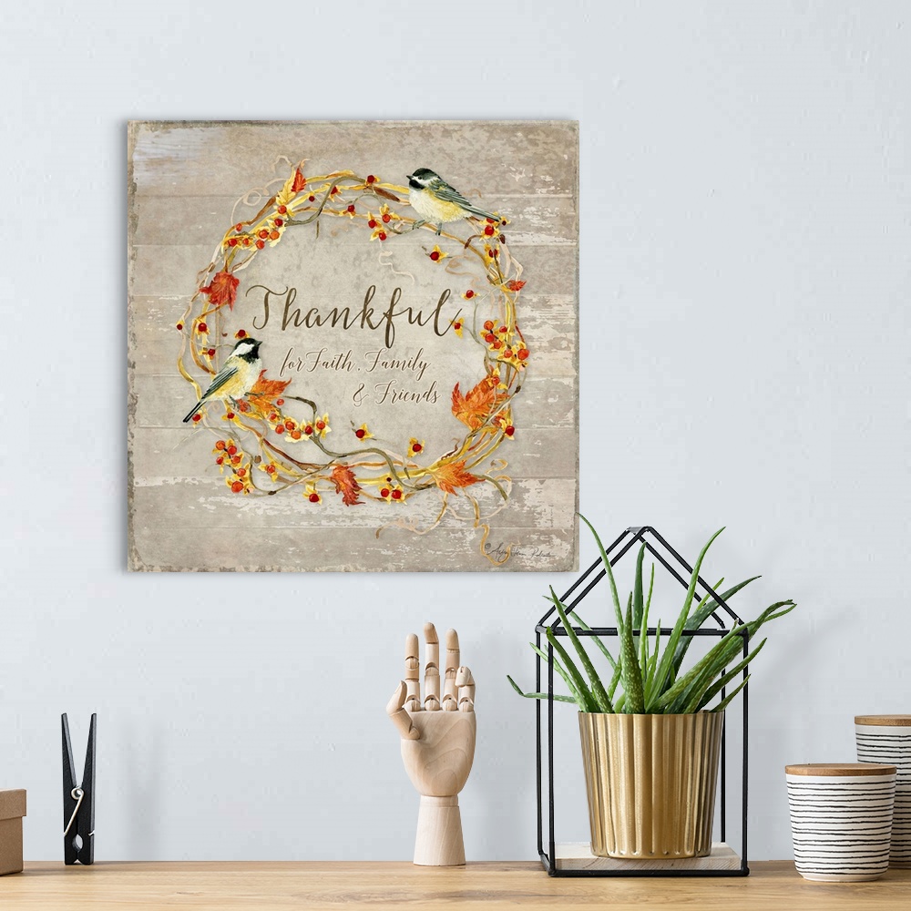 A bohemian room featuring Thanksgiving decor of a wreath made of leaves and berries with two chickadees.