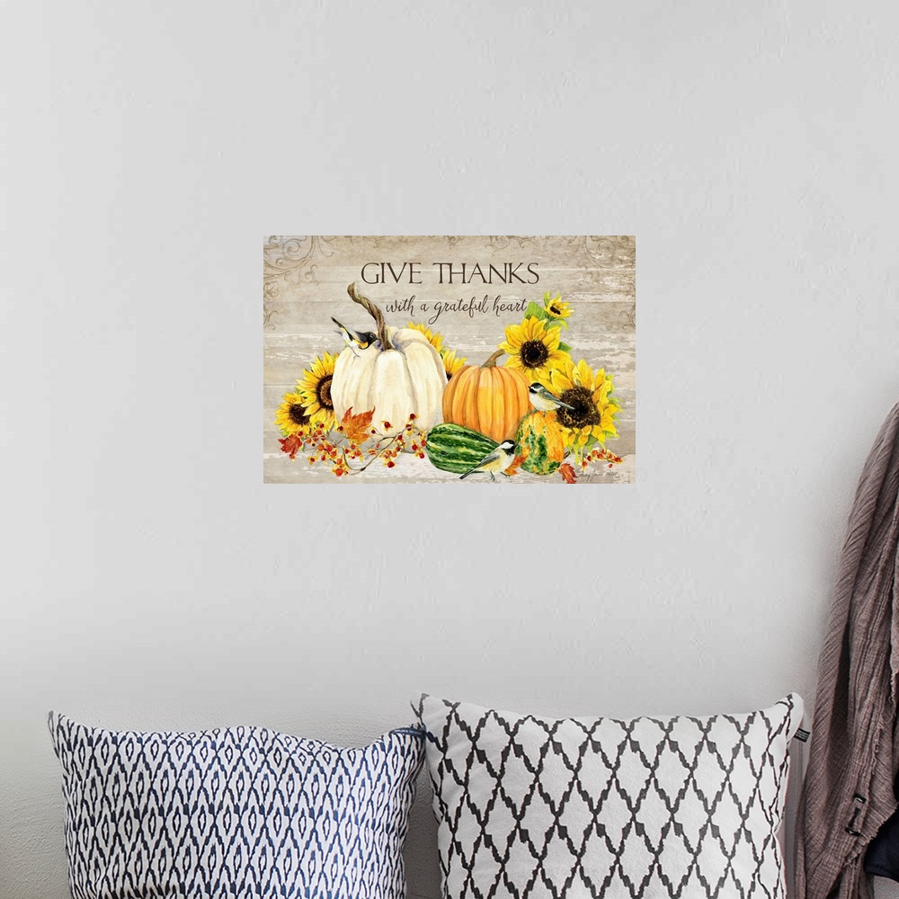 A bohemian room featuring Thanksgiving decor of a white pumpkin, squash, and sunflowers with small birds.