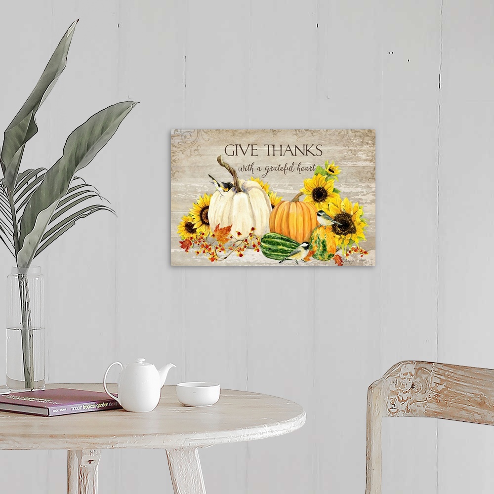 A farmhouse room featuring Thanksgiving decor of a white pumpkin, squash, and sunflowers with small birds.