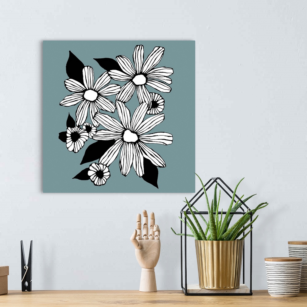 A bohemian room featuring Contemporary artwork of white flowers in a bold black outline against a muted blue background.