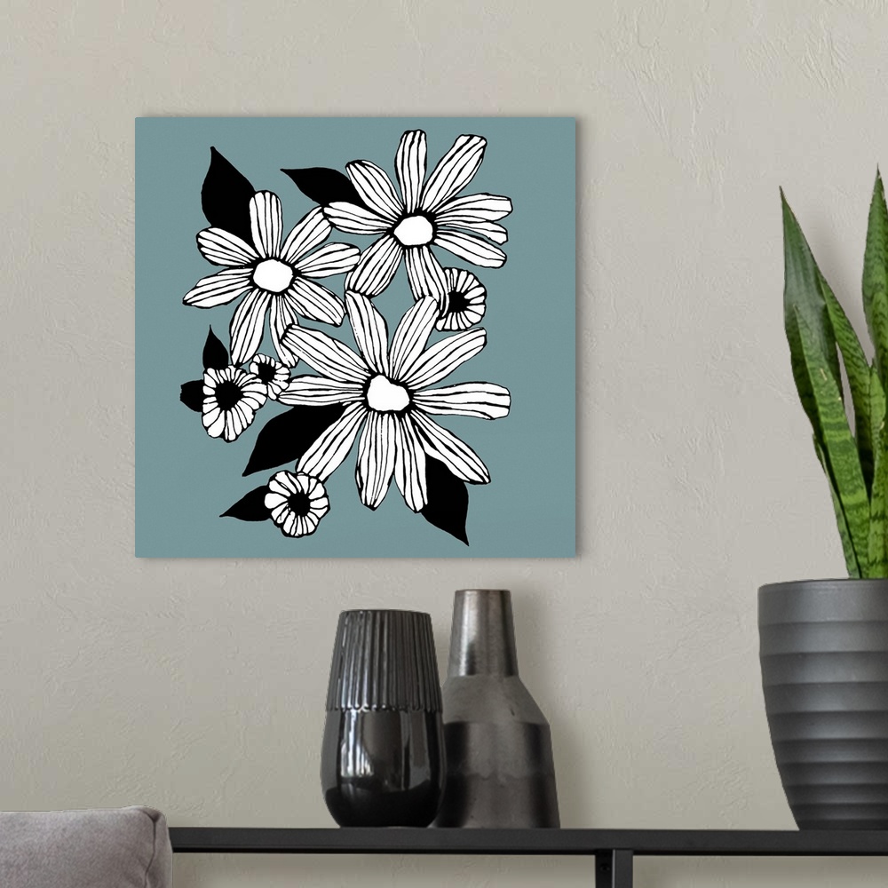 A modern room featuring Contemporary artwork of white flowers in a bold black outline against a muted blue background.