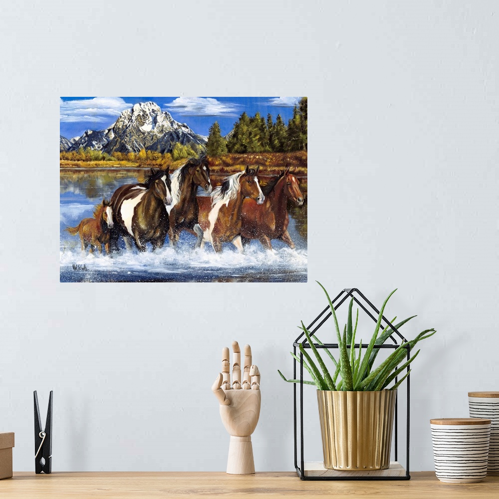 A bohemian room featuring Contemporary artwork of a herd of horses as they gallop through shallow water. A snow capped moun...