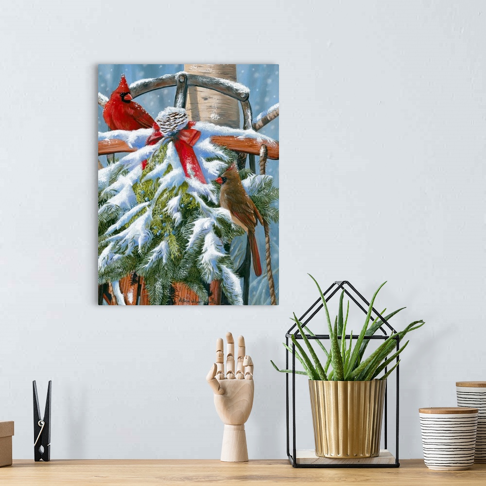 A bohemian room featuring This large artwork piece shows two cardinals standing in a snow covered wreath that covers an old...