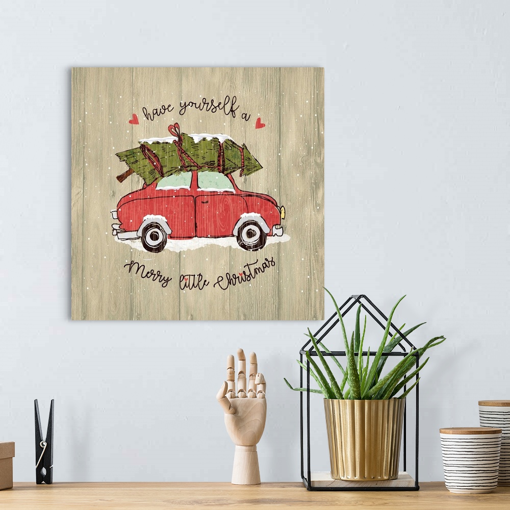 A bohemian room featuring Christmas decor of a car carrying a Christmas tree on a wooden background.