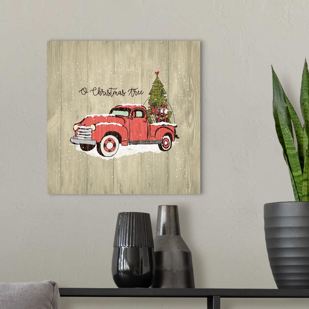 A modern room featuring Christmas decor of a vintage red truck carrying a Christmas tree and presents.