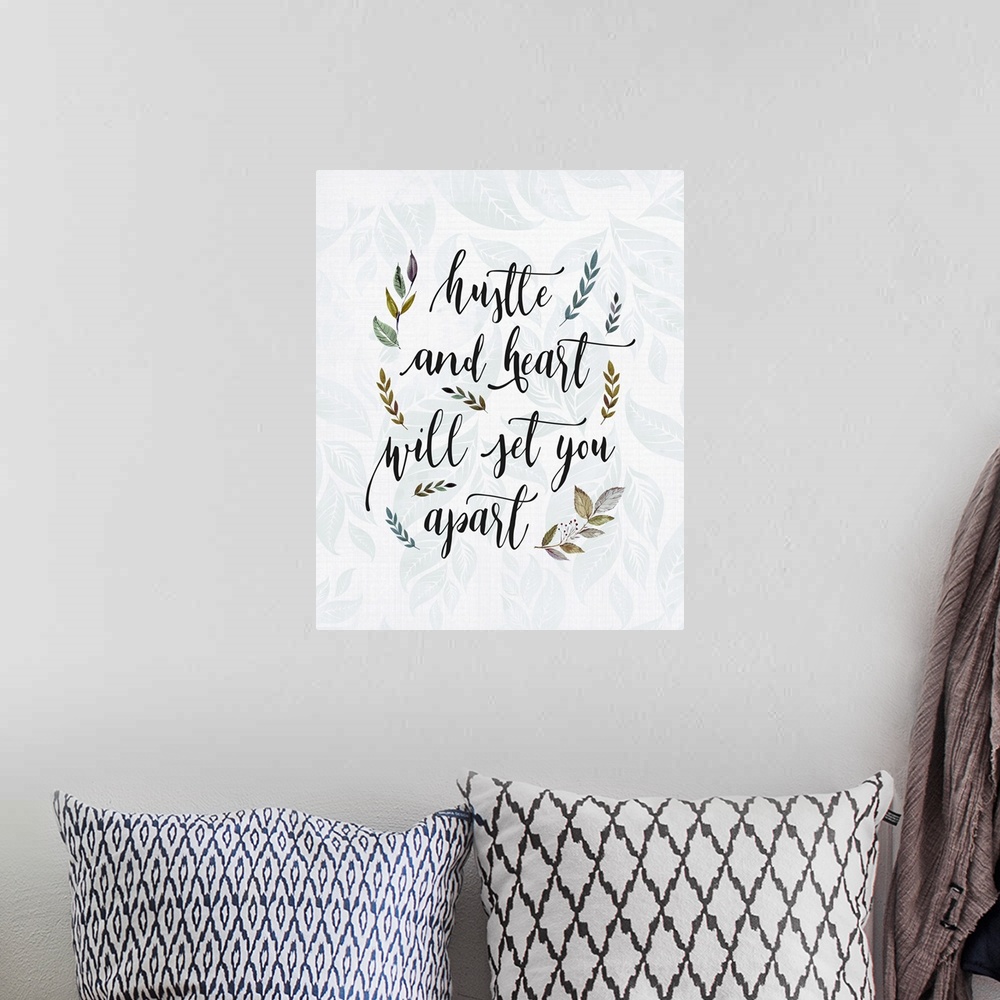 A bohemian room featuring Textual art of an inspirational statement in a script font, surrounded by branch and leaf graphic...