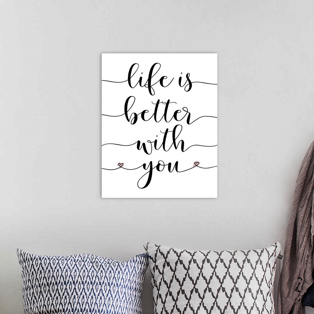 A bohemian room featuring "Life is Better With You" hand-lettered in black on a white background.