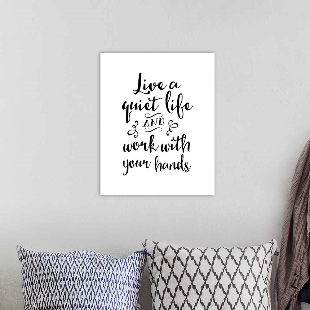 A bohemian room featuring Textual art of an inspirational statement in a script font, in several lines stacked vertically, ...