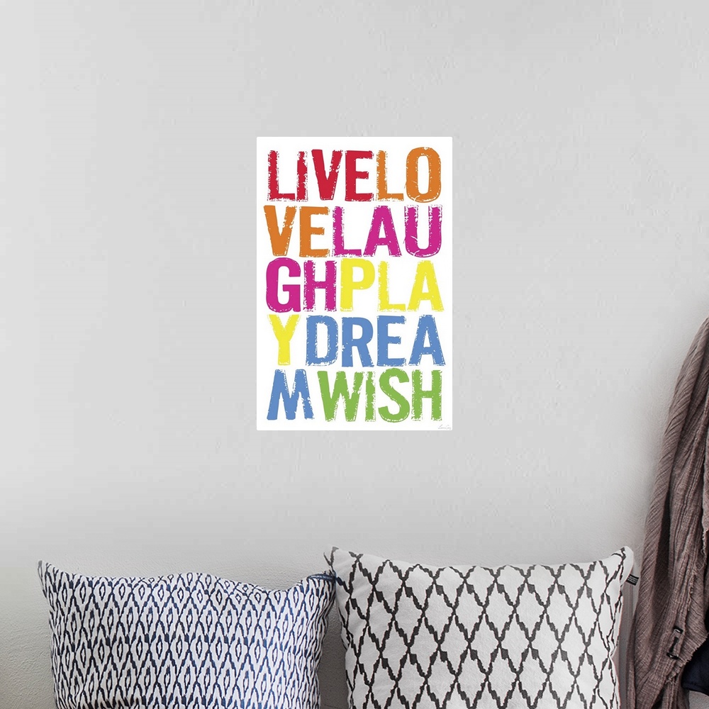 A bohemian room featuring Wall art of brightly colored words on top of a blank canvas.