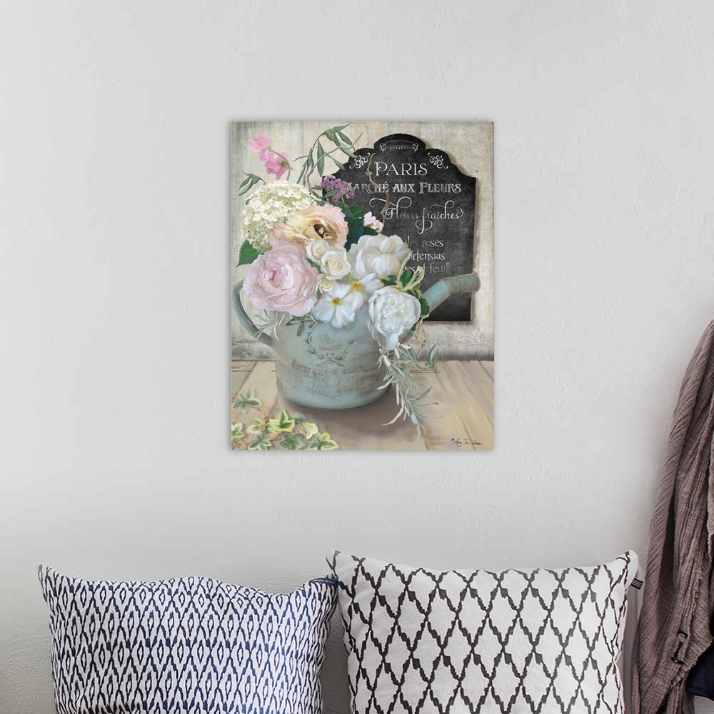 A bohemian room featuring A bouquet of roses and peonies in an old watering can next to a chalkboard sign.