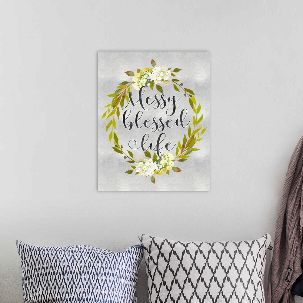 A bohemian room featuring A wreath of flowers and leaves surround the words, "Messy blessed life" .