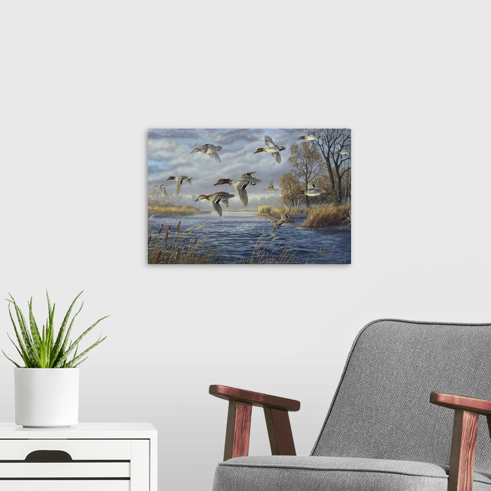 A modern room featuring Contemporary artwork of a flock of green-winged teals in flight over a river.
