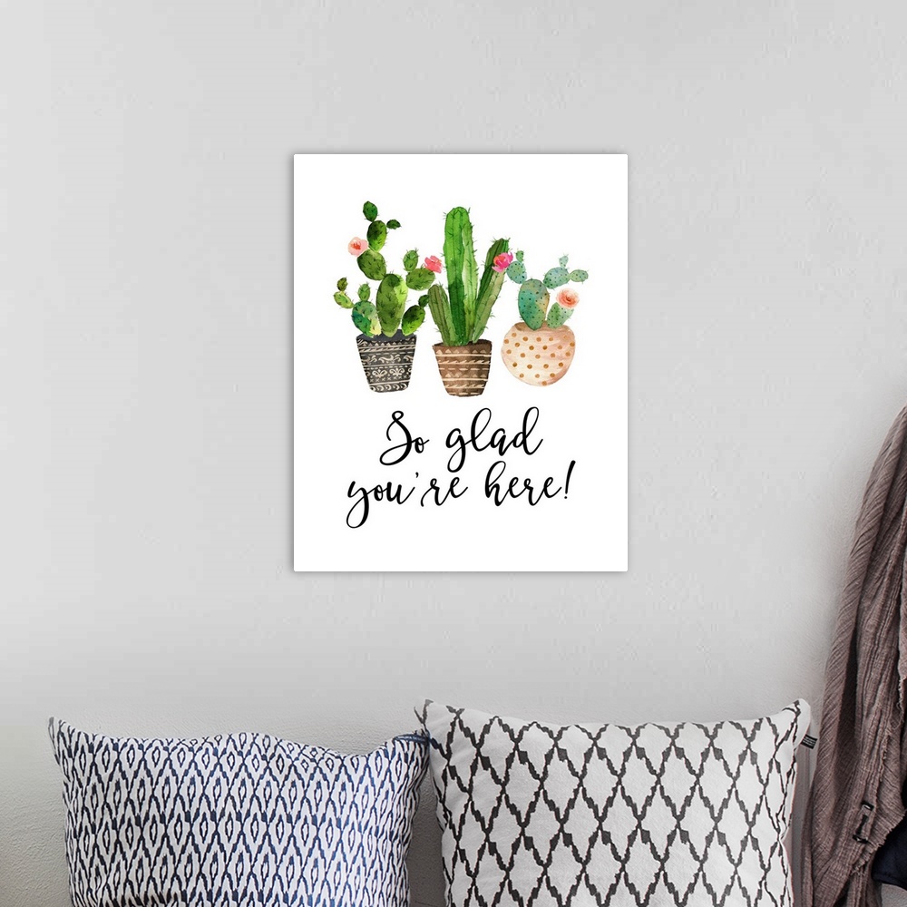 A bohemian room featuring This decor features watercolor cactus plants with the words, "So glad you're here!" underneath.