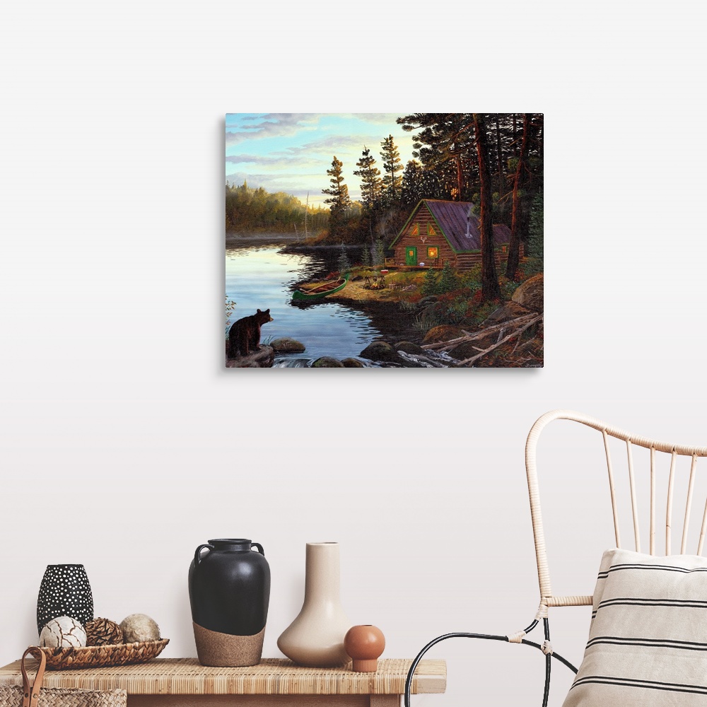 A farmhouse room featuring Photograph of cabin in the woods by lake with canoe under a cloudy sky.  There is a bear on the o...