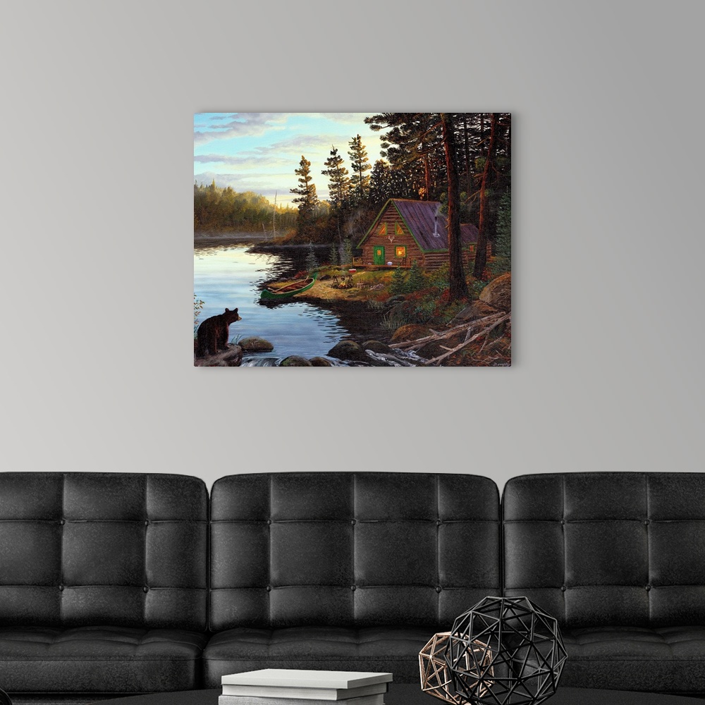 A modern room featuring Photograph of cabin in the woods by lake with canoe under a cloudy sky.  There is a bear on the o...