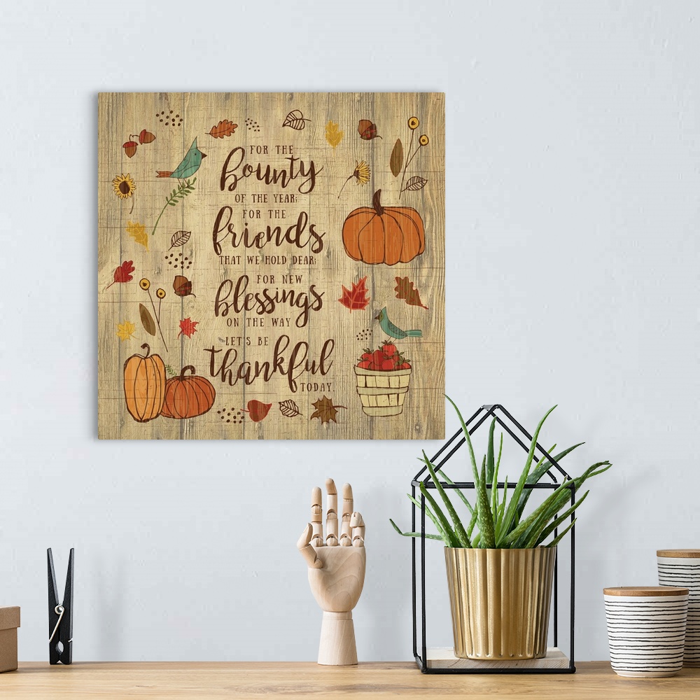 A bohemian room featuring Thanksgiving themed decor of pumpkins, leaves, and birds surrounding a thankful prayer.