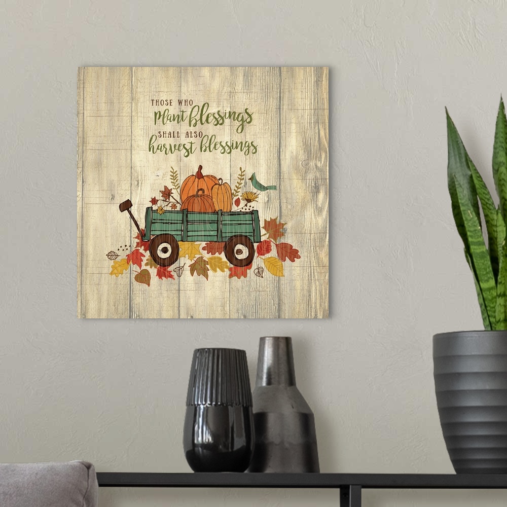 A modern room featuring Thanksgiving themed decor of a wagon filled with pumpkins on a leafy trail.