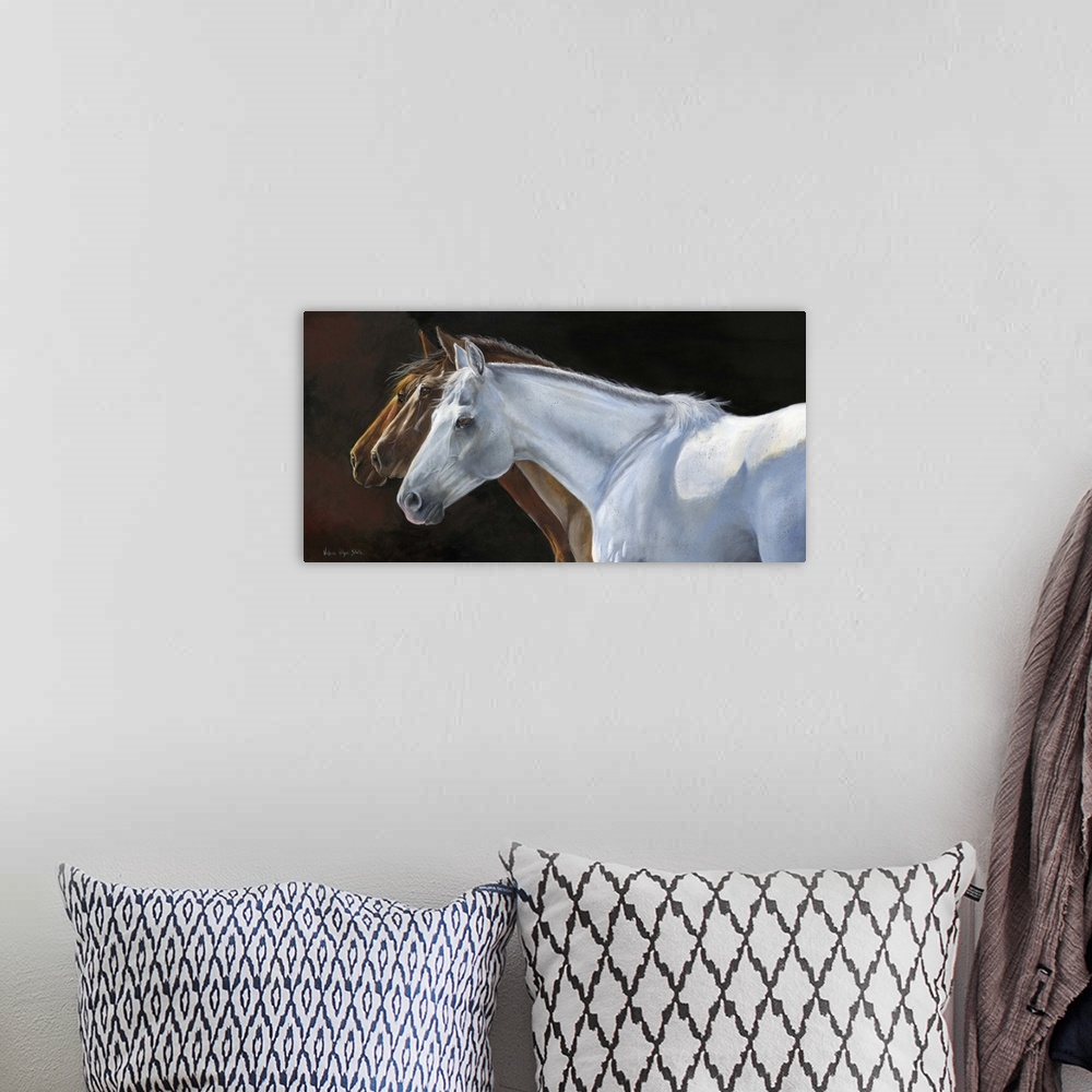 A bohemian room featuring Contemporary painting of three horses in profile.