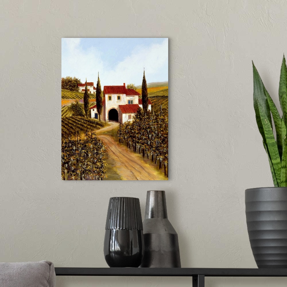 A modern room featuring Painting of a red roofed Tuscan villa in the middle of a vineyard.