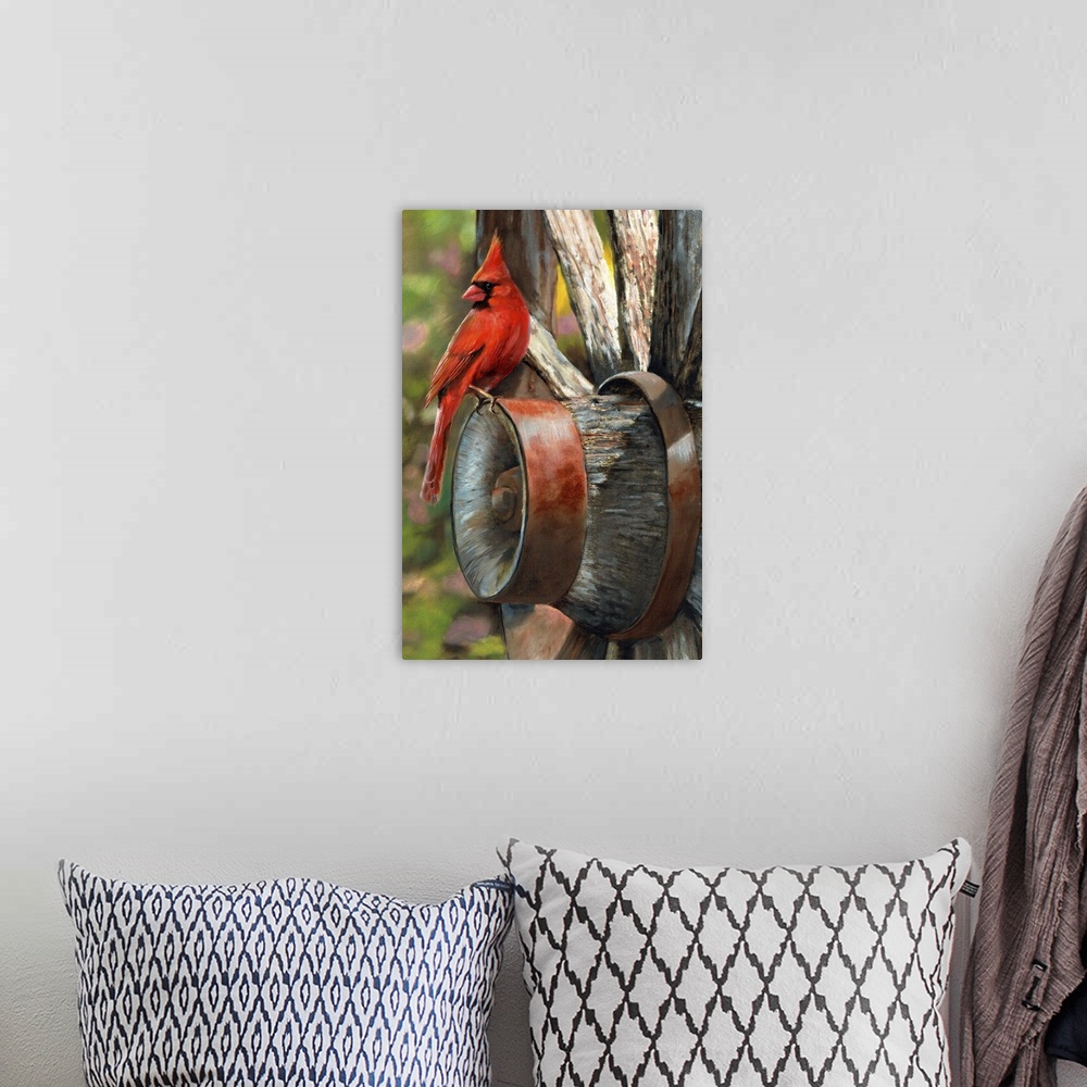A bohemian room featuring A bright red cardinal sitting on the edge of a wagon wheel.