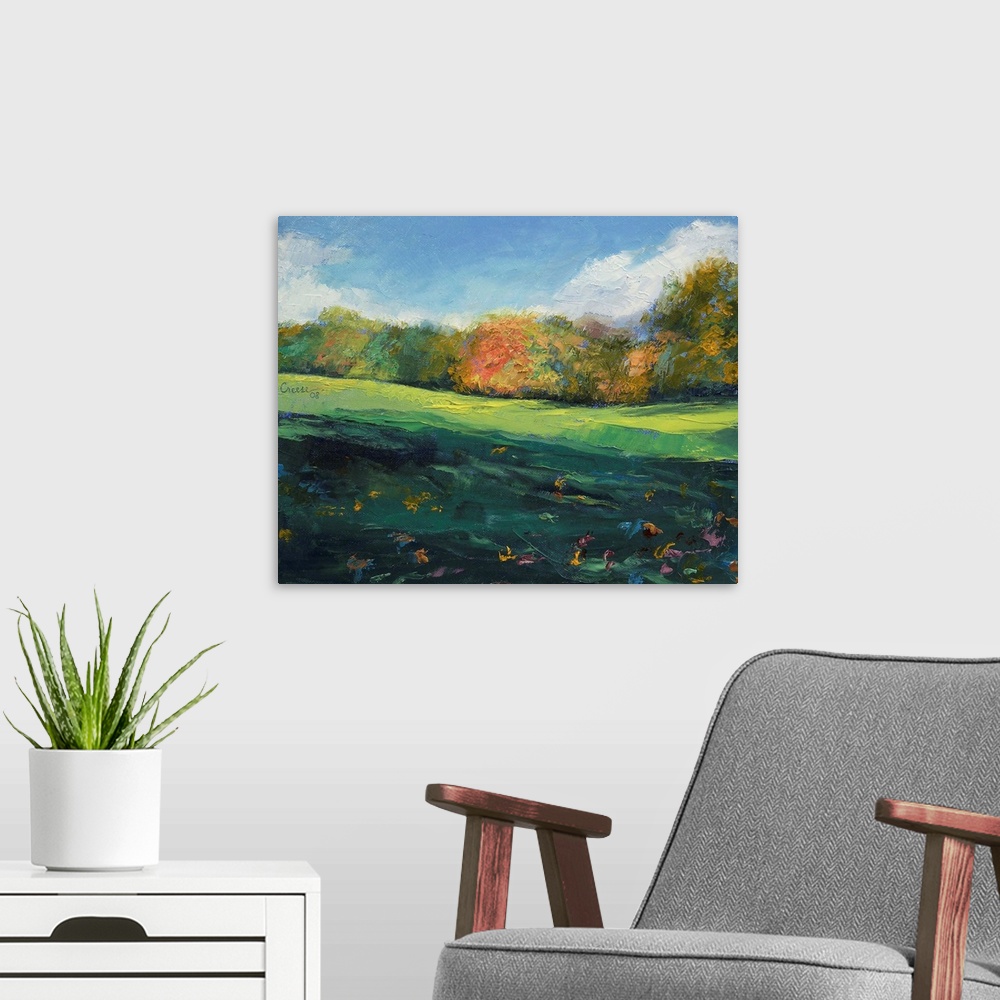 A modern room featuring Landscape painting on a large wall hanging of a rolling, green landscape with autumn colored tree...