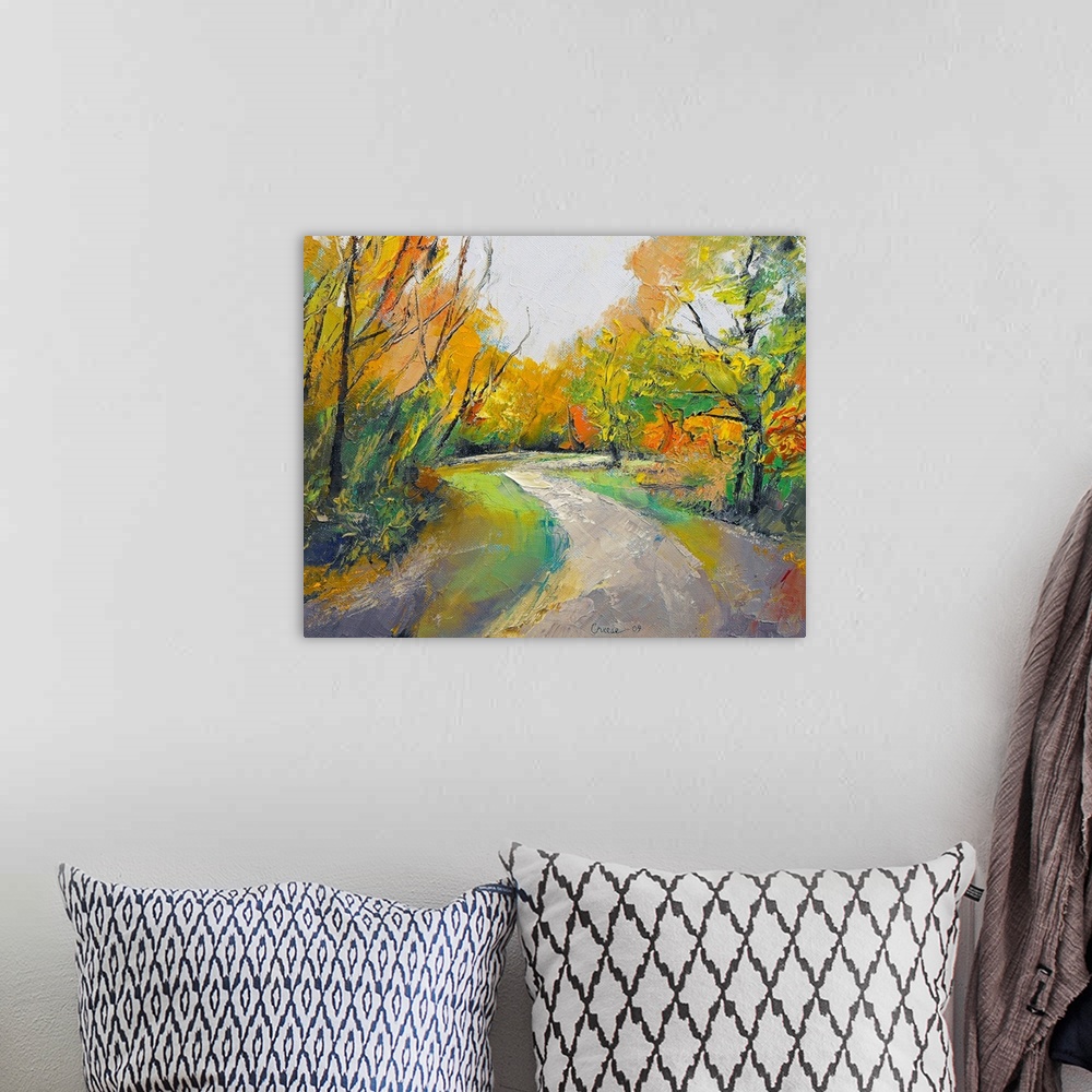 A bohemian room featuring Painting of a road in the middle of a forest in the fall.