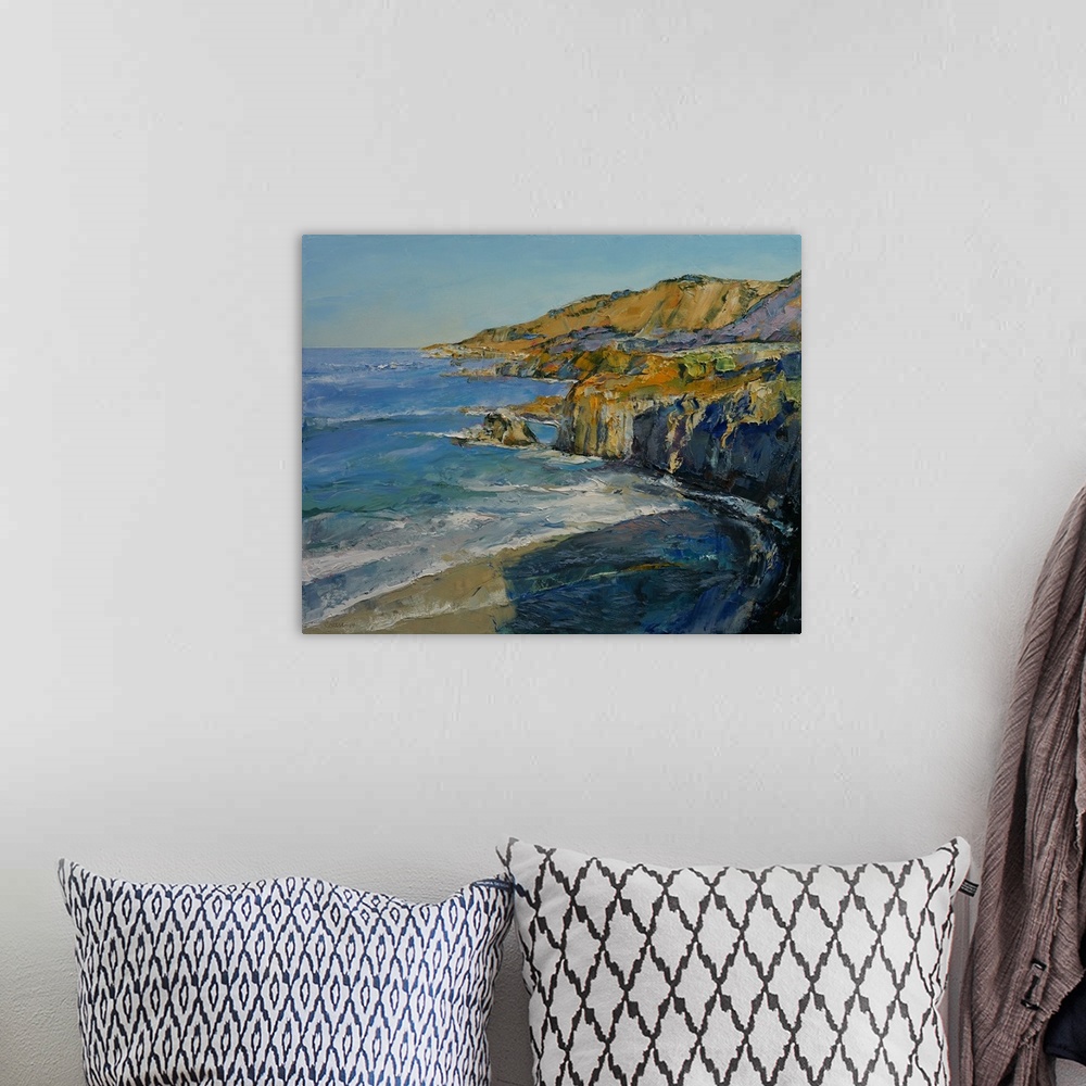 A bohemian room featuring A contemporary painting of a the Big Sur coastline.