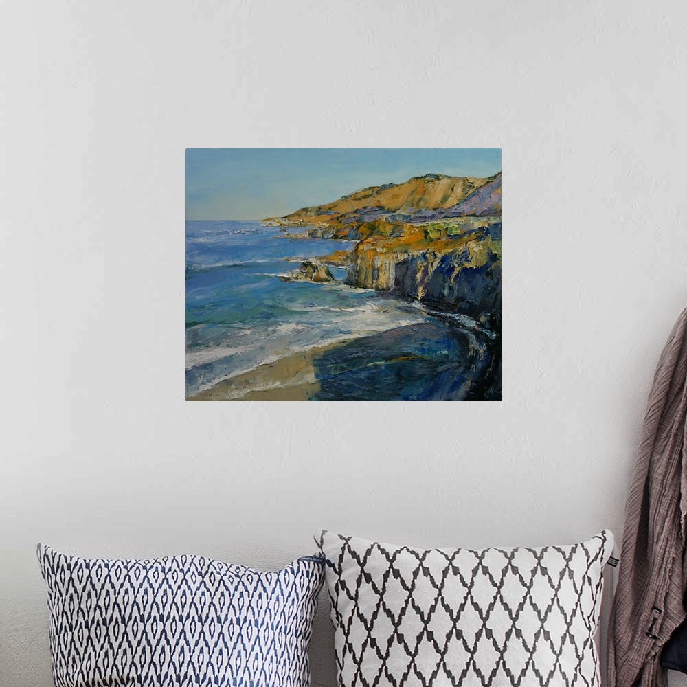 A bohemian room featuring A contemporary painting of a the Big Sur coastline.