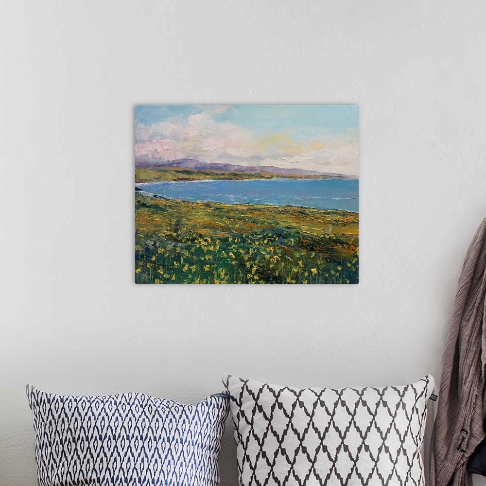 A bohemian room featuring A contemporary painting of a coastal Californian landscape.