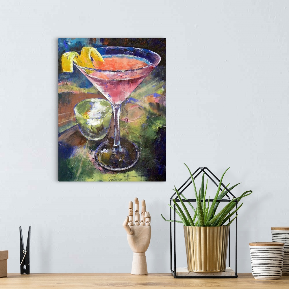 A bohemian room featuring Large artwork of a martini glass filled with a pink drink and a lemon twist on the side. A small ...