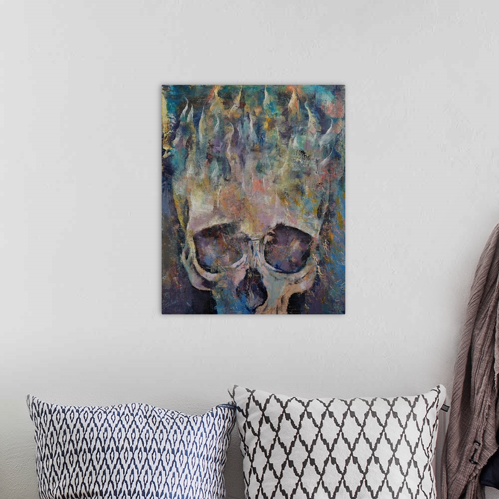 A bohemian room featuring A contemporary painting of a human skull with flames rising from the top.