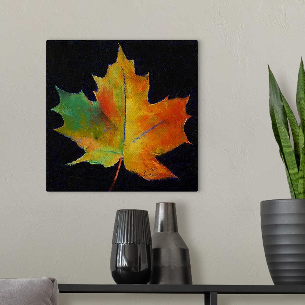 A modern room featuring Square painting on a large canvas of a vibrant, fall colored leaf on a black background.