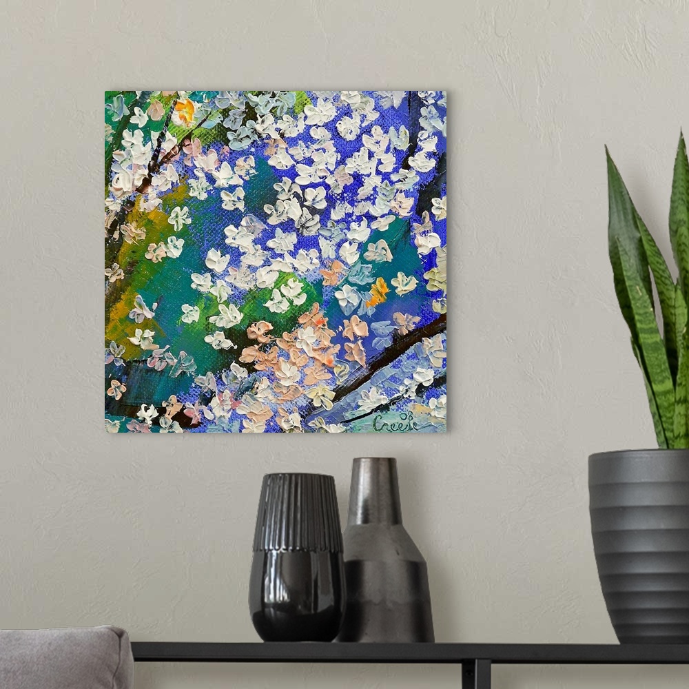 A modern room featuring An abstracting paining of tree branches with thick dabs of paint to make the floral blossoms on t...