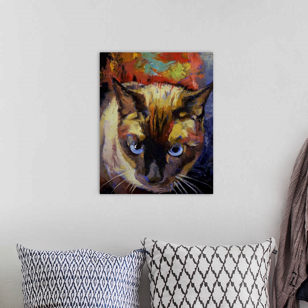 A bohemian room featuring Vertical, oversized painting looking down at the face of a Seal Point Siamese cat, on a backgroun...