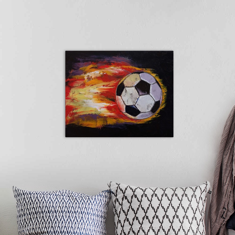 A bohemian room featuring Contemporary painting of a soccer ball with flames streaming from it.