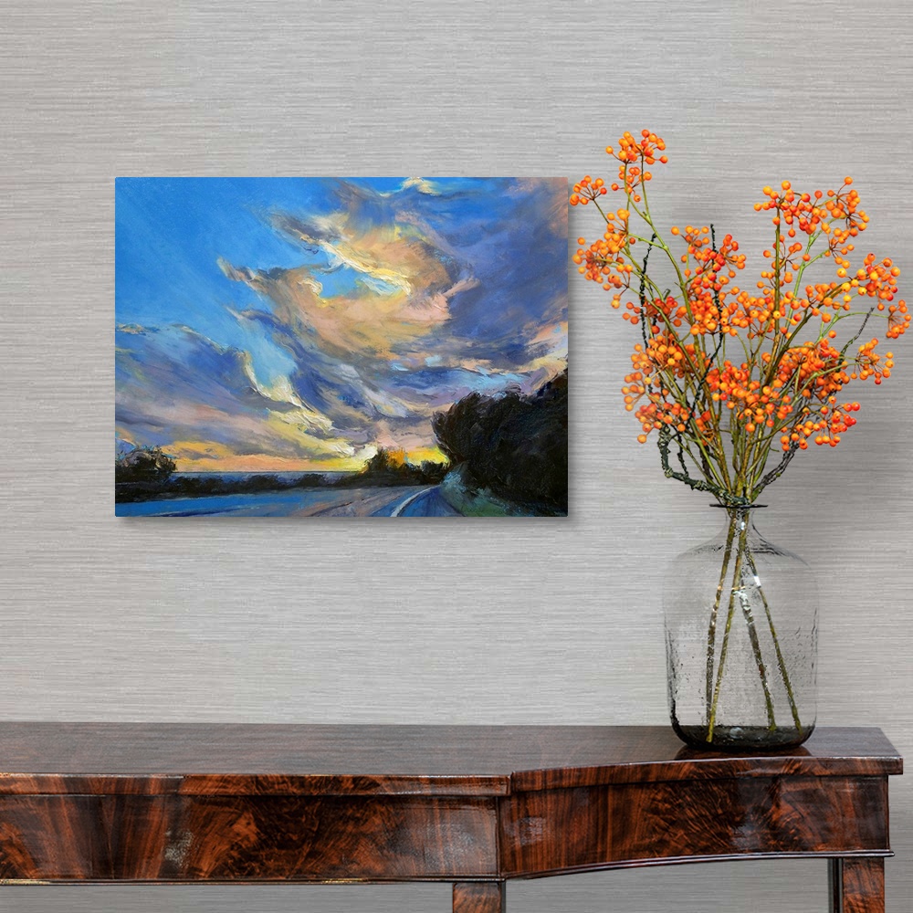A traditional room featuring Horizontal painting on large canvas of a road leading into the sunset, beneath a sky of swirling ...
