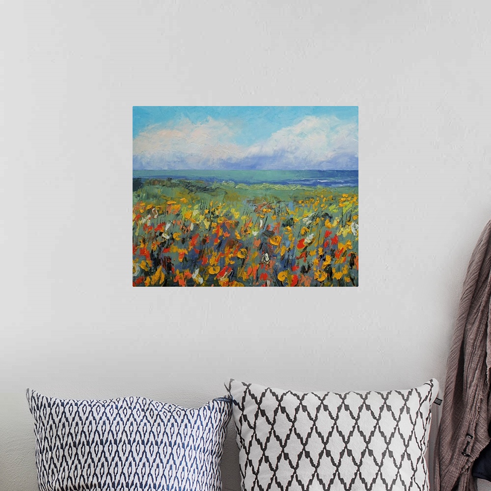 A bohemian room featuring Giclee print of an oil painting depicting a field of flowers, the ocean, and sky full of fluffy c...
