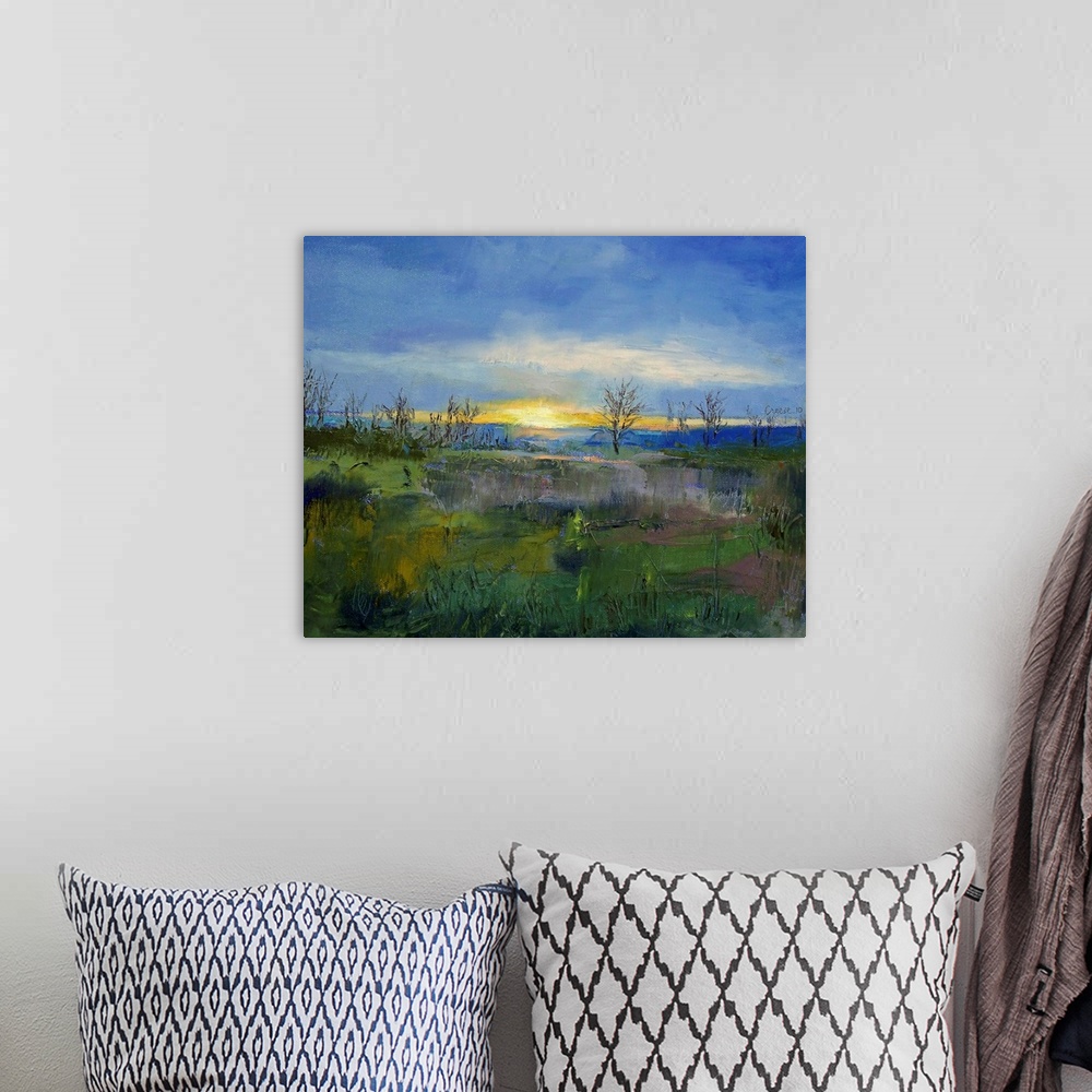 A bohemian room featuring Oil Painting of the sun's last rays of light on the horizon with bare trees and a grassy field in...