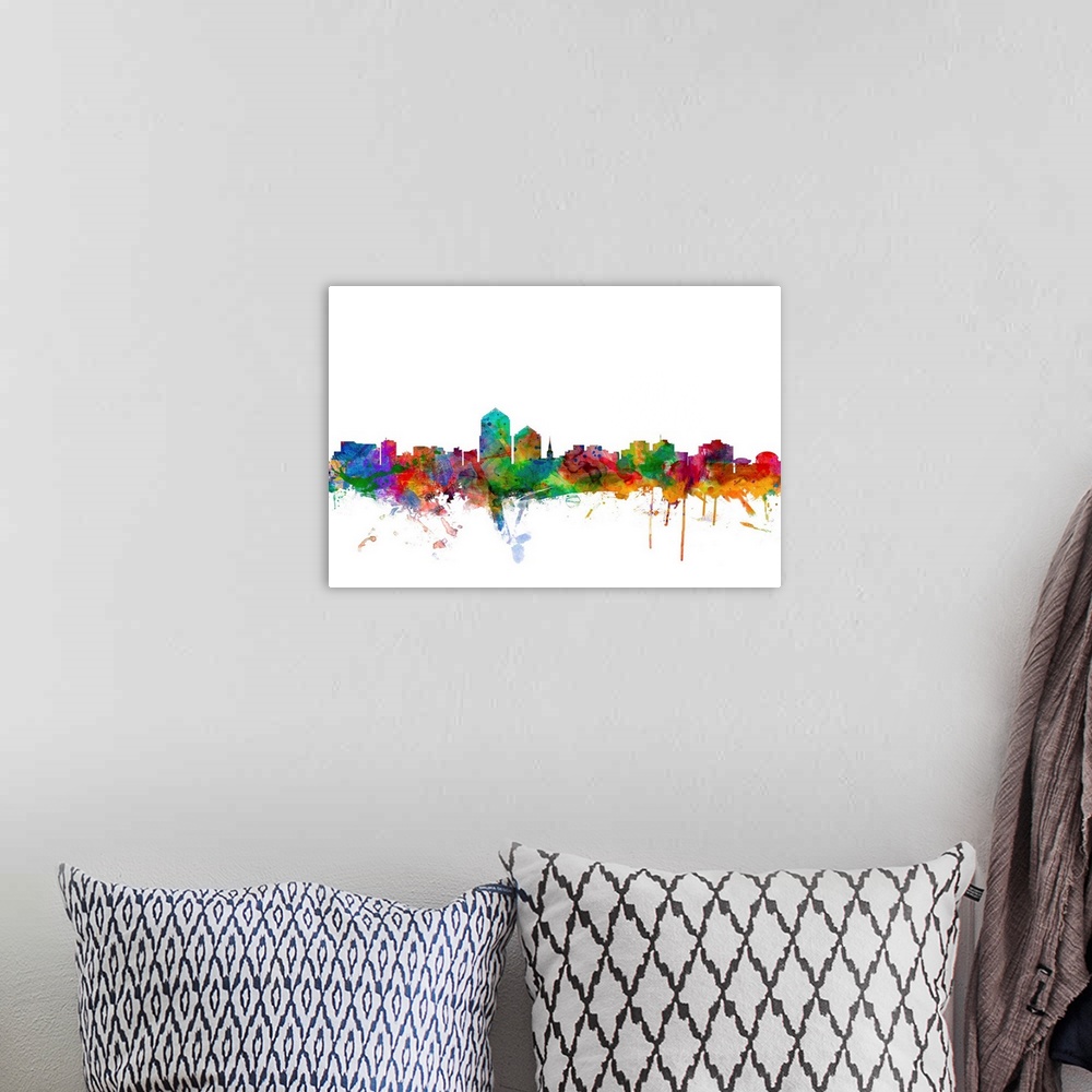 A bohemian room featuring Watercolor artwork of the Albuquerque skyline against a white background.