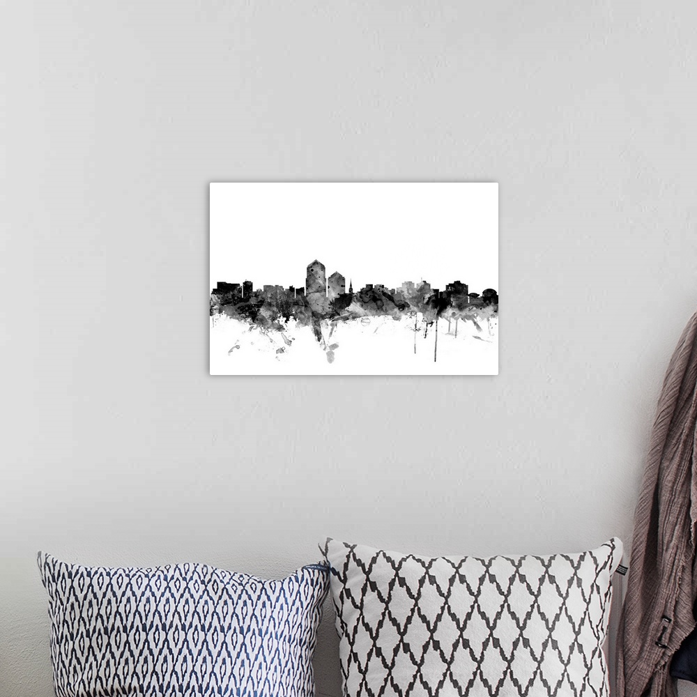 A bohemian room featuring Contemporary artwork of the Albuquerque city skyline in black watercolor paint splashes.